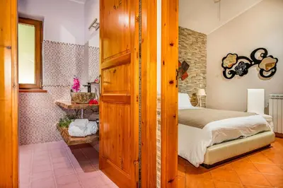a bedroom with a bed and a shower at Palma Dello Zingaro in Scopello