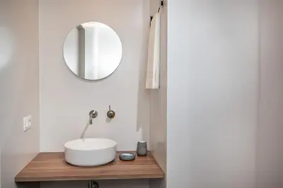a bathroom with a shower with a sink and a mirror at BED 10.5 - DESIGN SUITE in Castellammare del Golfo