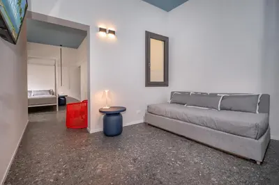 a bedroom with a bed and a table with a lamp at BED 10.5 - DESIGN SUITE in Castellammare del Golfo