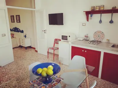 a kitchen and a dining room with a table at Atelier House 69 in Trappeto