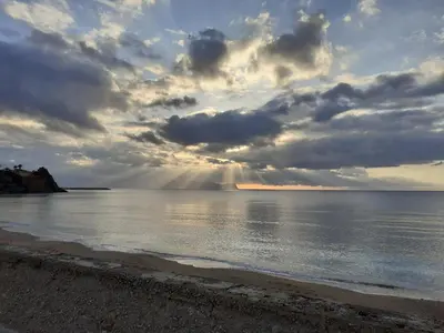a group of people walking on the beach at Atelier House 69 in Trappeto