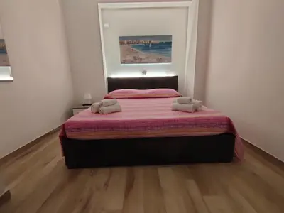 a bedroom with a bed with two towels on it at Les Voiles in Terrasini