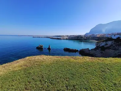 a body of water with rocks in the water at Les Voiles in Terrasini