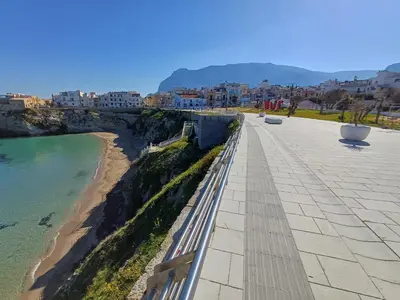 a view of a beach with buildings and the ocean at Les Voiles in Terrasini