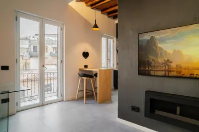 a living room with a fireplace and a painting on the wall at Politeama Centre in Palermo