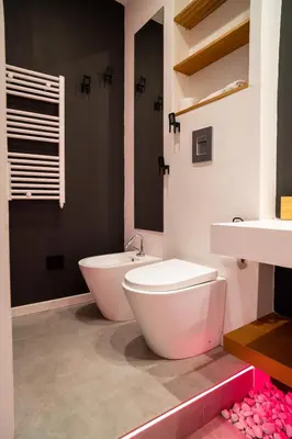 a bathroom with two toilets and a tub and a sink at Politeama Centre in Palermo