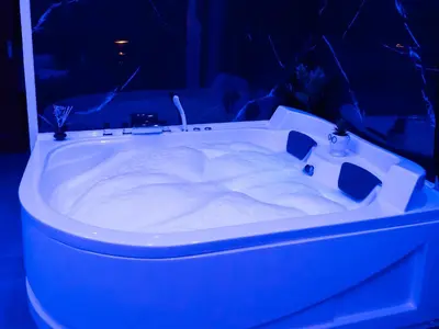 a white bath tub in a dark room at Aliva suite LT in Palermo