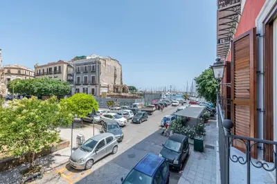 a city street with cars parked in a parking lot at Apartments La Cala by Wonderful Italy in Palermo