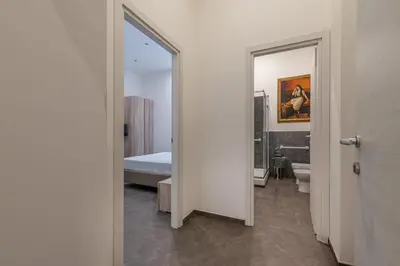 a bathroom with a mirror and a toilet and a bed at Apartments La Cala by Wonderful Italy in Palermo