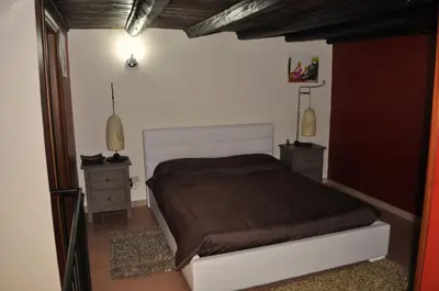 a bedroom with a bed and two night stands at Kalza House in Palermo