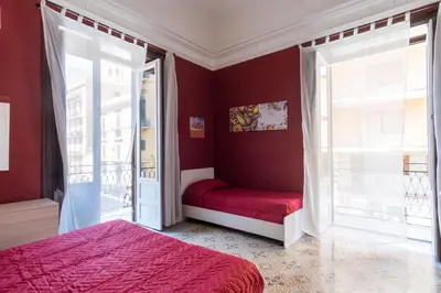 a red bedroom with a red bed and a window at Corner Rome 433 in Palermo
