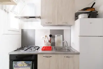 a small kitchen with a stove and a sink at Corner Rome 433 in Palermo