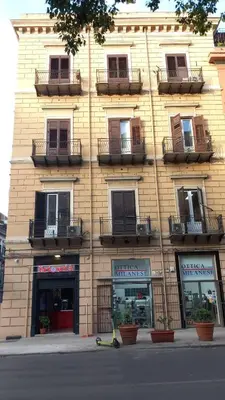 a building with windows and a scooter in front of it at Corner Rome 433 in Palermo