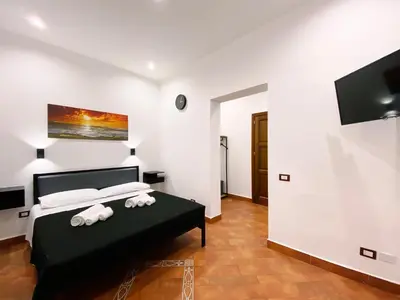 a bedroom with a bed with towels on it at Aliva room LT in Palermo