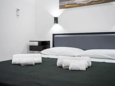 a bedroom with two white towels on a bed at Aliva room LT in Palermo