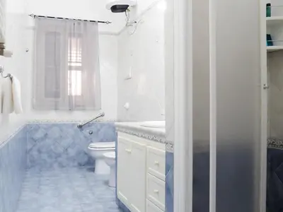 a white bathroom with a toilet and a sink at Aliva room LT in Palermo