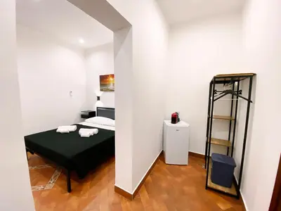 a small room with a bed and a ladder at Aliva room LT in Palermo
