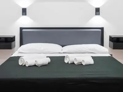 a bed with three rolls of towels on it at Aliva room LT in Palermo