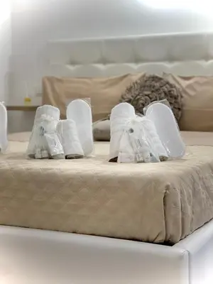 a bed with towels and shoes on top of it at A casa di ilary in Palermo