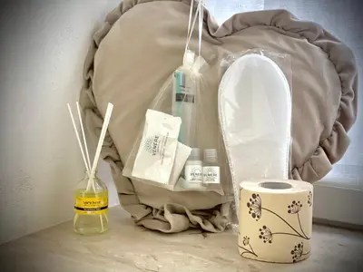 a table with a bag and a bottle of moisturizers at A casa di ilary in Palermo