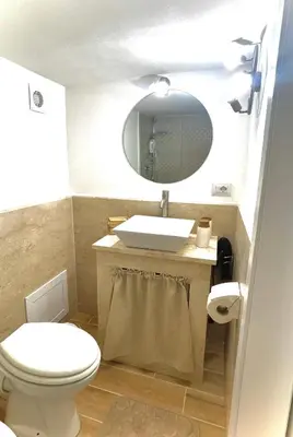 a bathroom with a toilet and a sink and a mirror at A casa di ilary in Palermo