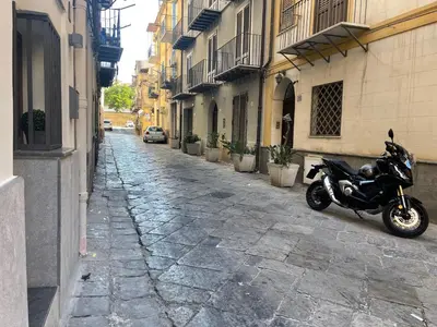 a motorcycle parked on the side of a street at A casa di ilary in Palermo