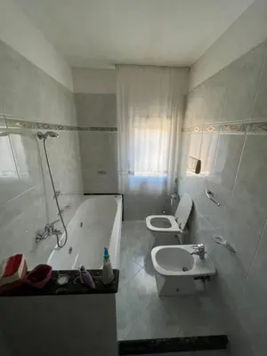 a bathroom with a tub and a toilet and a sink at Appartamento Gemma D'oro in Castellammare del Golfo