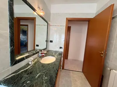 a bathroom with a sink and a large mirror at Appartamento Gemma D'oro in Castellammare del Golfo