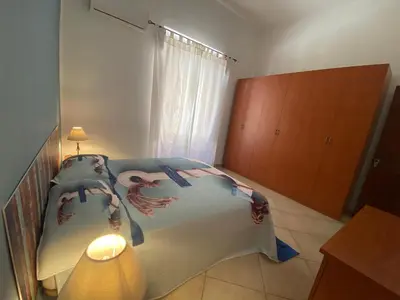 a bedroom with a bed and a lamp in it at Le_case_di_Antonella - your holiday in Sicilia in Castellammare del Golfo
