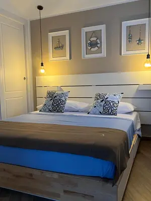 a bedroom with a large bed with blue sheets and pillows at Cortile dei Mori in Palermo