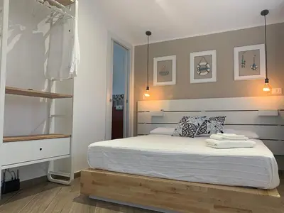 a bedroom with a white bed with a wooden frame at Cortile dei Mori in Palermo