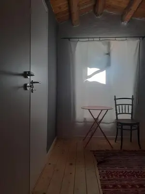 a room with a table and a chair and a window at Domus 31 in Palermo