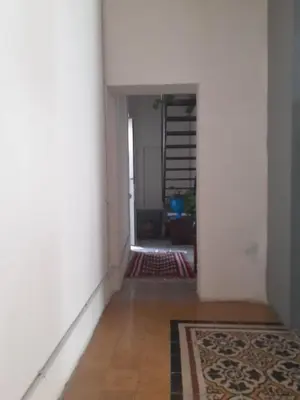 an empty hallway with a rug and a stair case at Domus 31 in Palermo