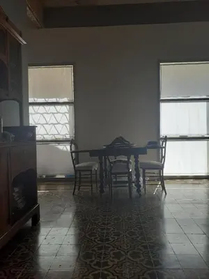 a dining room with a table and four chairs at Domus 31 in Palermo