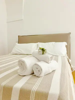 a bed with towels on top of it at Giardino Segreto Luxury Home in Palermo