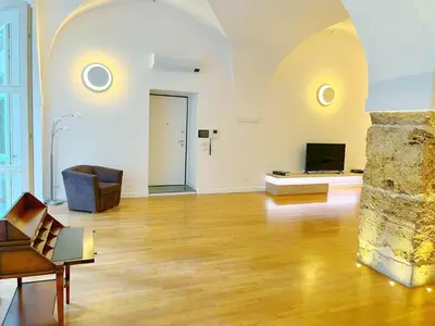 a large living room with a couch and a television at Giardino Segreto Luxury Home in Palermo