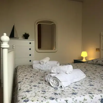 a bedroom with two towels on a bed at Villa Fede & Niki in San Vito lo Capo