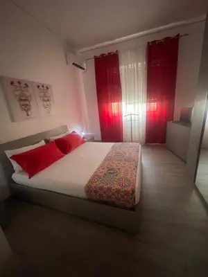 a bedroom with a large bed with red curtains at OUR BEAUTIFUL SICILY in Palermo