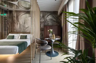 a hotel room with a bed and a table at Aquasuite - Luxury Experience & Spa in Palermo