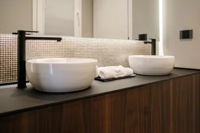 two white sinks on a counter in a bathroom at Aquasuite - Luxury Experience & Spa in Palermo