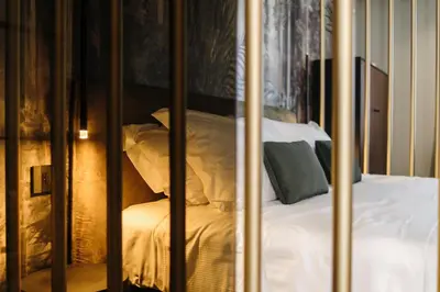 a bed with white sheets and pillows in a room at Aquasuite - Luxury Experience & Spa in Palermo