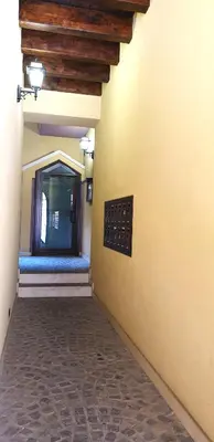an empty hallway of a building with a window at I Vicini del Re Holiday Home in Palermo