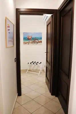 an open door to a room with a bike on the wall at I Vicini del Re Holiday Home in Palermo
