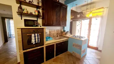 a kitchen with a stove and a sink in it at A Casa di Sasy in Palermo