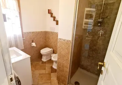 a bathroom with a shower and a toilet and a sink at A Casa di Sasy in Palermo
