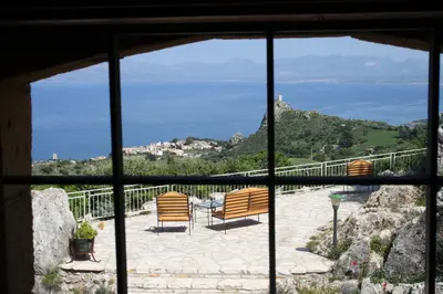 a view from a window of a patio with chairs at Casale Corcella in Scopello