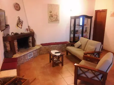a living room with a couch and a fireplace at Casale Corcella in Scopello