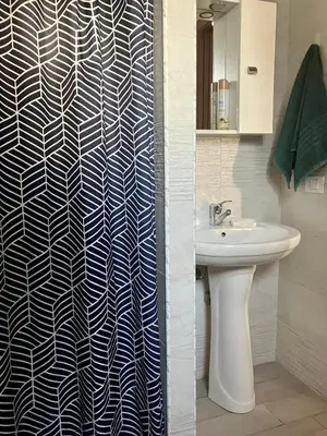 a bathroom with a sink and a shower curtain at Itaca in Palermo