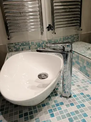 a white sink in a bathroom with a tiled floor at Casa Dadà, romantic house in historic centre in Palermo