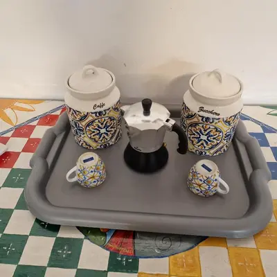 a tray with a tea pot and cups on a table at Aspettando Vossia in Palermo